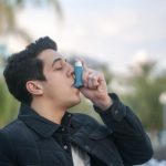 asthmatic-man-using-inhaler-outside